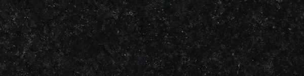 A black granite surface with some white spots.