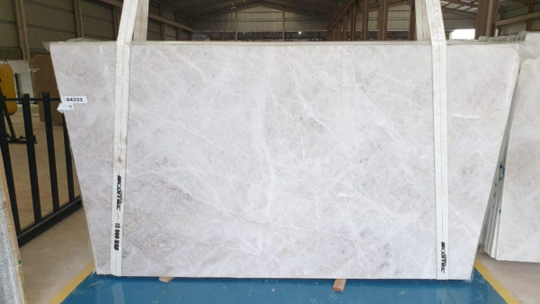 A white marble slab sitting on top of a floor.