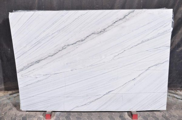 A white marble slab with some red stands
