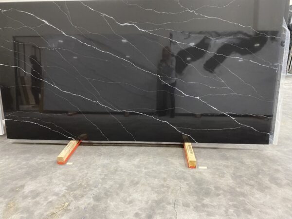 A black marble slab with orange sticks on top of it.