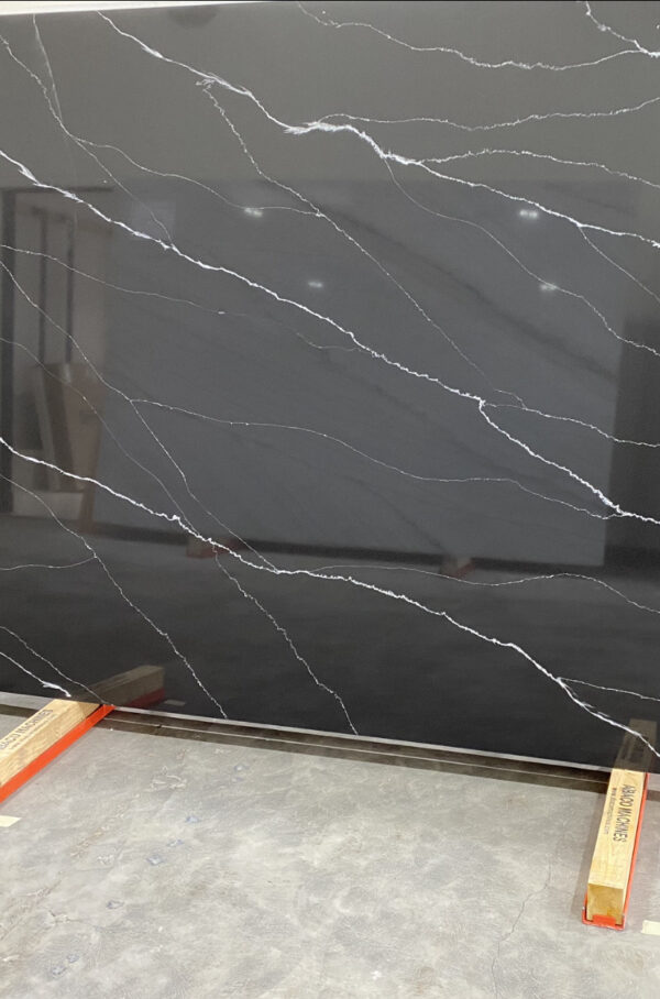 A black marble slab with white veins on it.