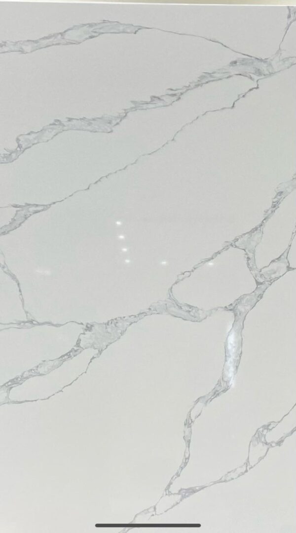 A white marble surface with some small dots on it