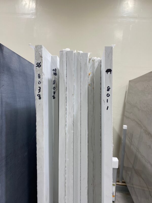 A stack of white boards with numbers on them.