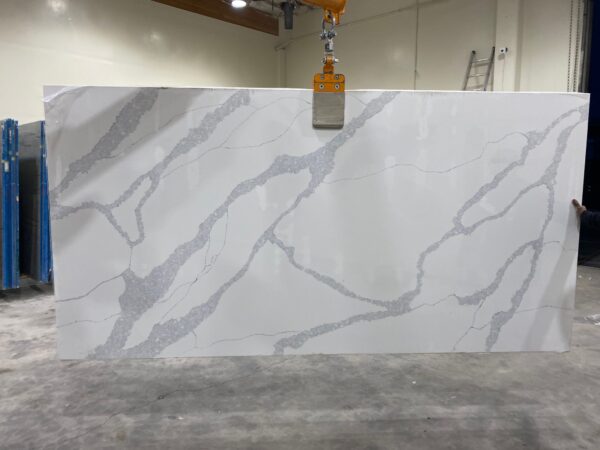 A slab of white marble with a crane hanging from it.