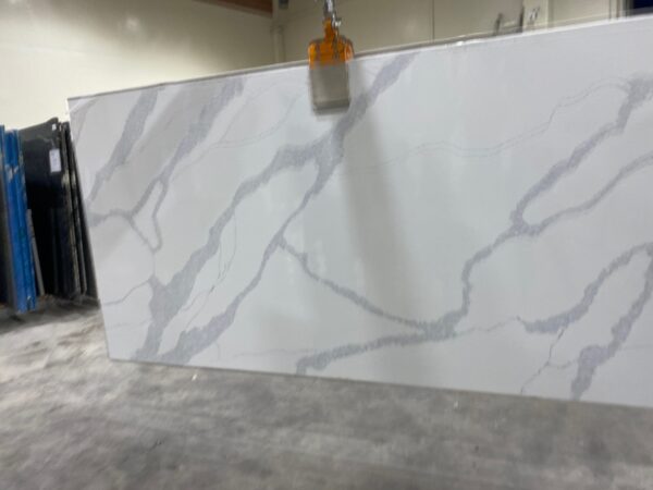A white marble slab with a small orange clip hanging on it.