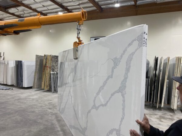 A person holding up a slab of marble