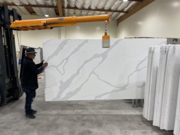 A man standing in front of some marble slabs.