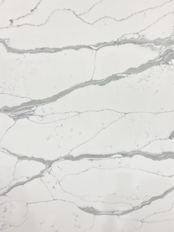 A white marble surface with some gray spots on it