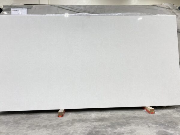 A white slab of marble in a warehouse.