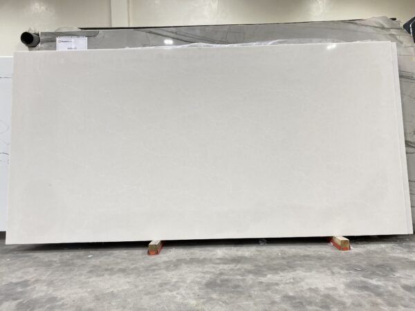 A white slab of marble on display in a warehouse.
