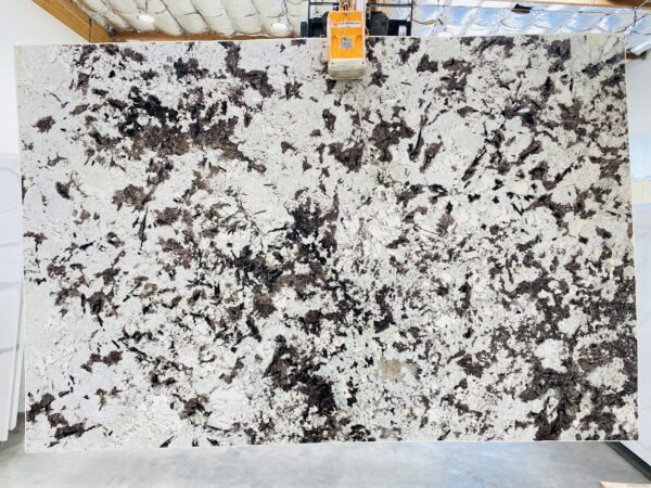A black and white marble slab with a yellow tag.