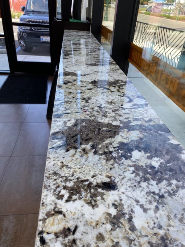 A marble counter top with black and white spots.