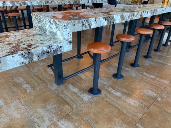 A table with four stools and two benches.