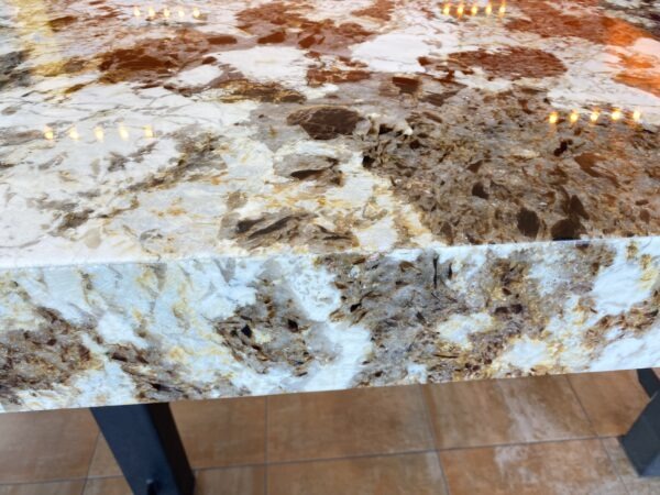 A close up of the counter top with brown and white marble.