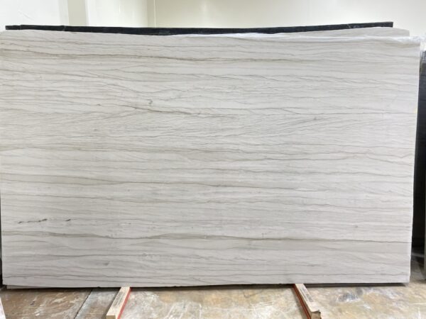 A white marble slab sitting on top of a wooden table.
