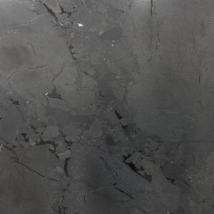 A gray marble surface with some small spots