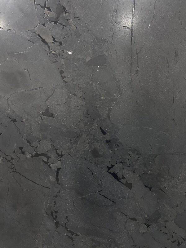 A gray marble surface with some small spots
