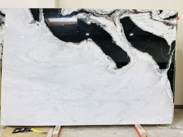 A black and white marble slab on top of a floor.