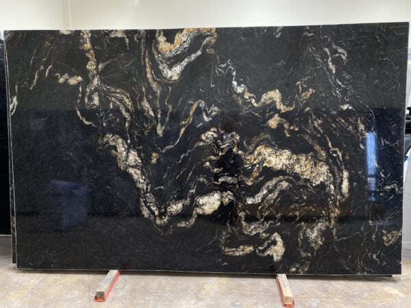 A slab of black and gold marble with some wood