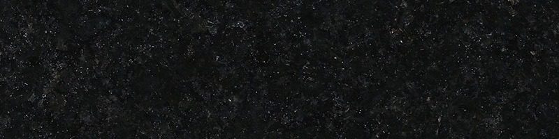 A black granite surface with some white spots.
